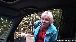 lovely older woman gives herself pleasure in her car